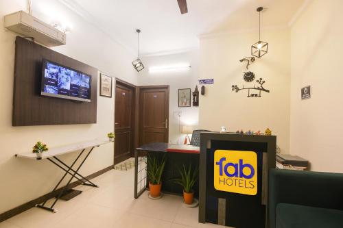 a hotel room with a tv on the wall at FabHotel Golf Luxury in Gurgaon