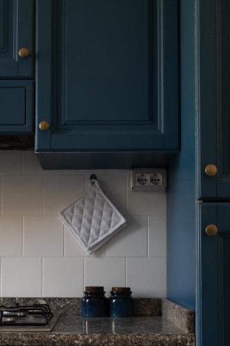 a kitchen with blue cabinets and a counter top at Terrazza Mira - Guest House in Todi