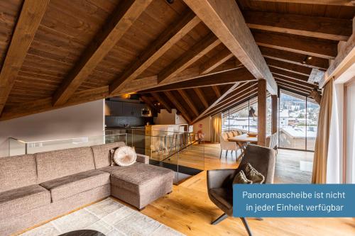 a living room with a couch and a table at Bergresort Zugspitze Ehrwald by ALPS RESORTS in Ehrwald