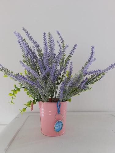 a pink pot with a lavender plant in it at Дом с террасой in Svyatopetrivske