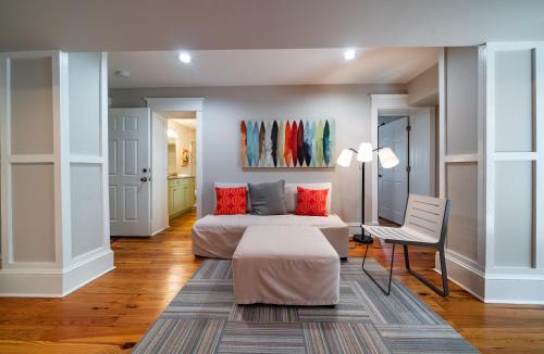 a bedroom with a bed and a table and a chair at 814 Carolina - Custom Private Home -Pool, Roof Top Deck in Isle of Palms
