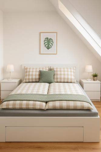 a bed in a white room with two night stands at Dat Fischerhuus in Pruchten