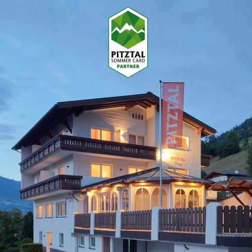 a large building with a sign in front of it at Pitztal Living Apartments in Jerzens