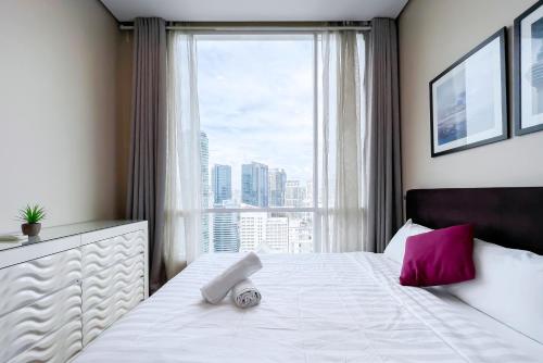 Ένα ή περισσότερα κρεβάτια σε δωμάτιο στο Soho Suites KLCC by GuestHouse
