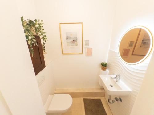 a bathroom with a white toilet and a sink at Charmantes Loft im Szeneviertel Hamburg-Ottensen in Niederdorla
