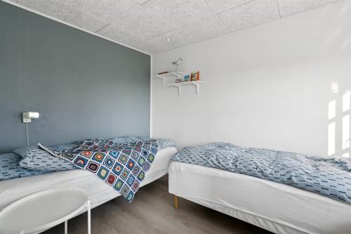 a bedroom with two beds and a sink at Modern Family House Near Købingsmark Beach in Nordborg
