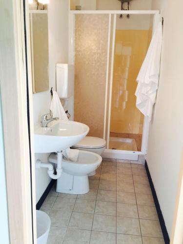 a bathroom with a toilet and a sink and a shower at Affitta camere Da Lalla in Dolcedo