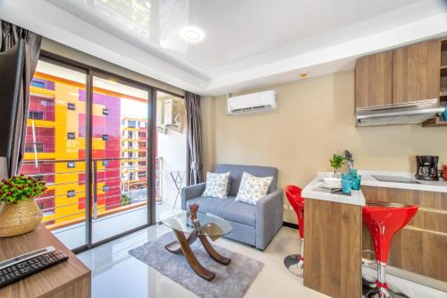 a living room with a couch and a table at SOLA Condo 1BR Tropical View NBC Nai Harn Nai in Rawai Beach
