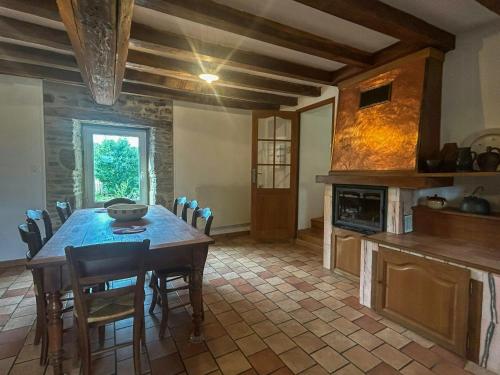 a kitchen with a table and chairs in a room at Family Home In The Alpes Mancelles in Moulins-le-Carbonnel
