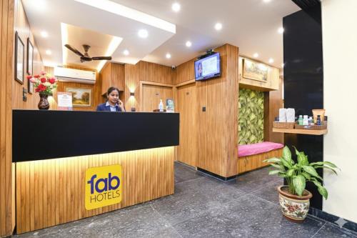 a woman standing at the counter of a hair salon at FabHotel Leela Inn - Nr Park Circus 7 Point in Kolkata