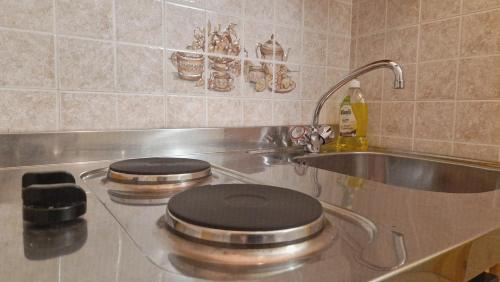 a kitchen with a stove top with a black lid at Lavarone & Folgaria Residence in Lavarone