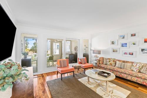 a living room with a couch and chairs and a table at Beach Club Villa 27 - Oceanview Walkout by Beach and Pool in Isle of Palms