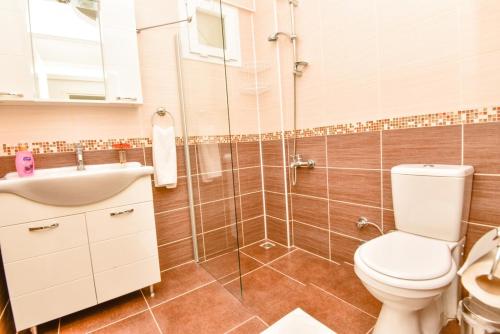 a bathroom with a toilet and a sink and a shower at Villa Maya The Royal Links Sarigerme in Sarigerme