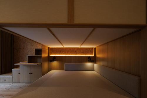 an empty room with a light on the wall at Changbai Mountain Lanpu Design Hotel in Antu