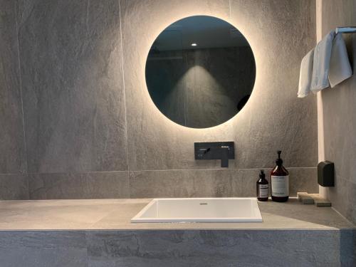 a bathroom with a sink and a mirror at Hotel SANG SANG & Private SANG SANG POOL VILLA in Geoje 