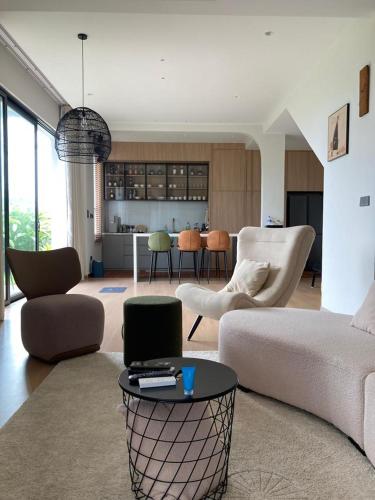 a living room with a couch and a table at Seaview Master Room - Ensuite Bath in Butterworth in Butterworth