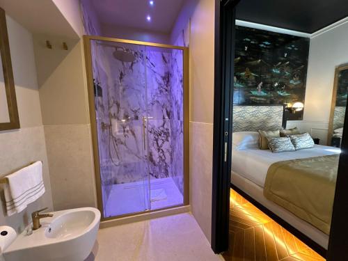 a bathroom with a shower and a sink and a bed at Torre Argentina Relais - Residenze di Charme in Rome