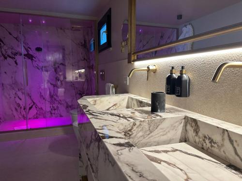 a bathroom with a large marble sink and a shower at Torre Argentina Relais - Residenze di Charme in Rome
