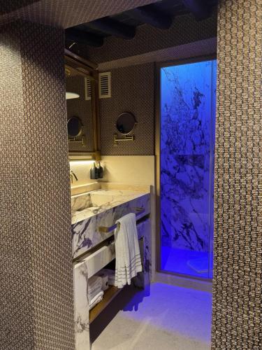 a bathroom with a sink and a large window at Torre Argentina Relais - Residenze di Charme in Rome