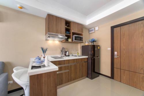 a small kitchen with a sink and a refrigerator at NARA Condo 1BR Pool View NBC Nai Harn in Nai Harn Beach