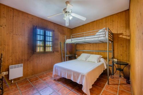 a bedroom with a bunk bed in a wooden wall at La Huerta Del Prado in Arcos de la Frontera