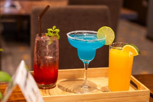 a tray with three cocktails on a table at Monsoon Bassac Hotel in Phnom Penh
