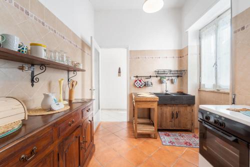 a large kitchen with a sink and a stove at Sardegna - Calasetta Paese in Calasetta