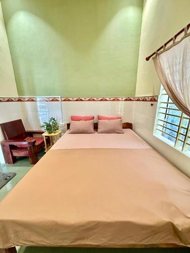 a bedroom with a large bed with two pillows at Dốc Lò - Homestay in Phú Hiệp (2)