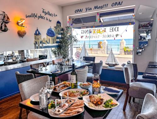 a table with plates of food in a restaurant at De L'Etang in Saint Helier Jersey
