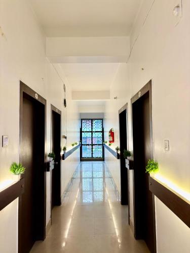a corridor of a building with a hallway at Nirvis Grand in Guwahati