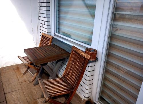 a table and two chairs sitting on a balcony at stan/apartman s pogledom in Sarajevo