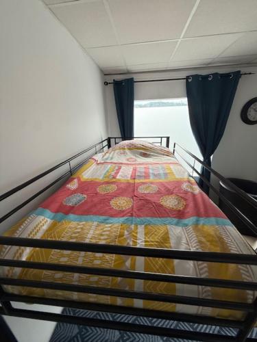 a bed in the back of a room at Appartement dans maison au calme in Forbach
