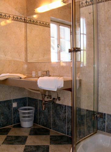 a bathroom with a sink and a shower at Gästehaus Hartweger in Haus im Ennstal