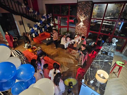 a group of people in a living room with balloons at 12th Avenue in Lahore