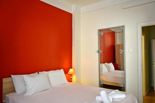 a bedroom with a white bed and a mirror at Aristotelous Boarding House in Thessaloniki