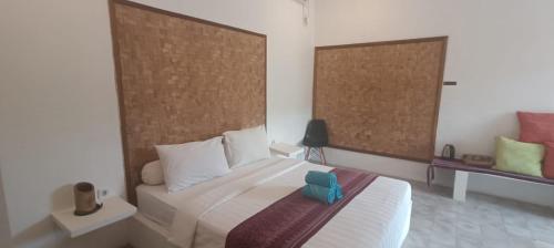 Nusa CeninganにあるJungle View Hostelのベッドルーム1室(青いオブジェクトのベッド1台付)