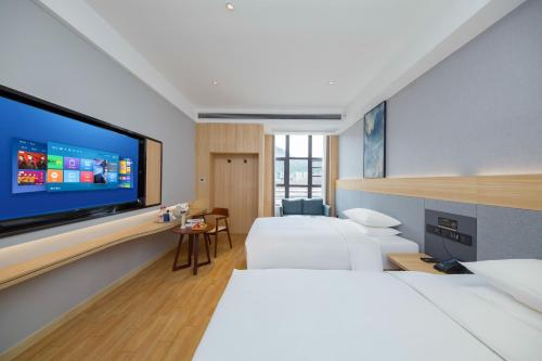 Ένα ή περισσότερα κρεβάτια σε δωμάτιο στο Imperial Dragon Bay Mandala Hotel