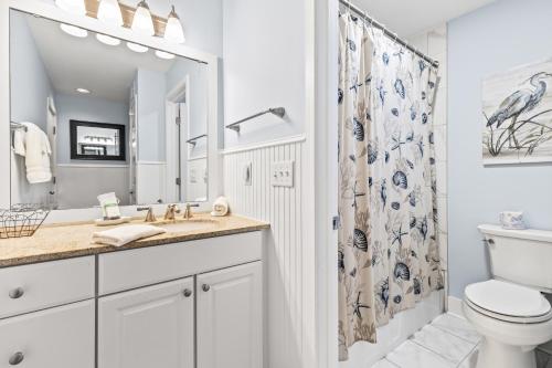 a bathroom with a sink and a toilet and a shower at Lagoon Villa 25 - Heart of Wild Dunes, Quick Walk to Beach in Isle of Palms