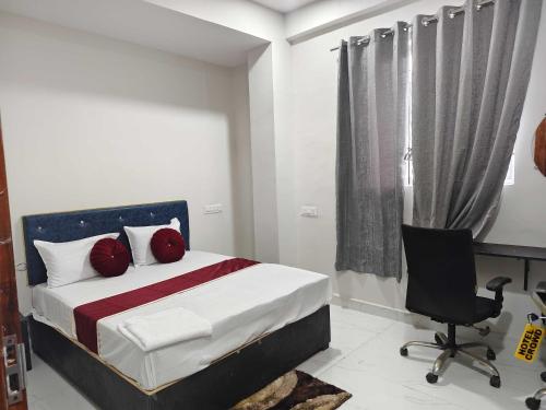 a bedroom with a bed and a desk and a chair at HOTEL O CROWD in Durg