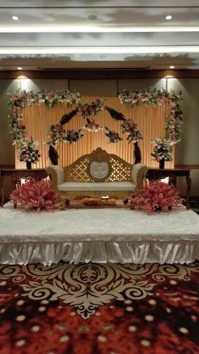 a stage with a table with flowers on it at Hotel Florence sector 46 in Gurgaon