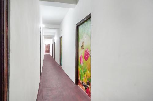 a hallway with a painting on the wall at SPOT ON Ap Logde in Māharjhari