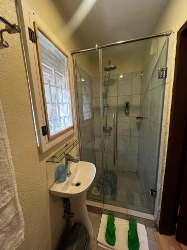 a bathroom with a shower and a sink and a shower at Kara Space BnB in Kampala
