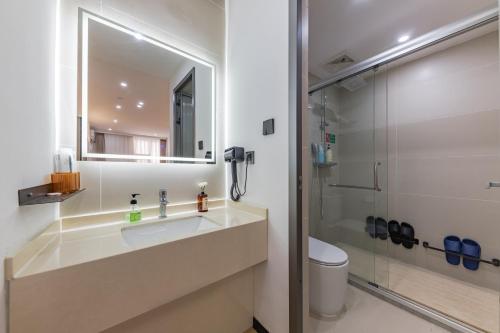 a bathroom with a sink and a shower at 尚品9号海景民宿Seaview Hotel in Xiamen