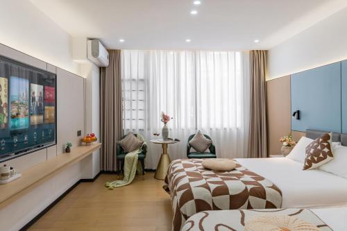 a hotel room with two beds and a flat screen tv at 尚品9号海景民宿Seaview Hotel in Xiamen