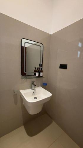 a bathroom with a sink and a mirror at Canberra Holidays - Mirissa in Mirissa