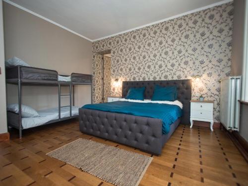 a bedroom with a large bed and bunk beds at Luxury Estate with Pool & Spa in Jamoigne