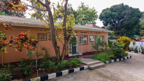 a house with a garden in front of it at Kara Space BnB in Kampala