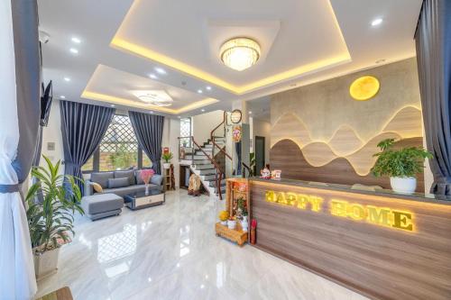 a living room with a home love sign on the wall at Happy Home Da Lat in Da Lat