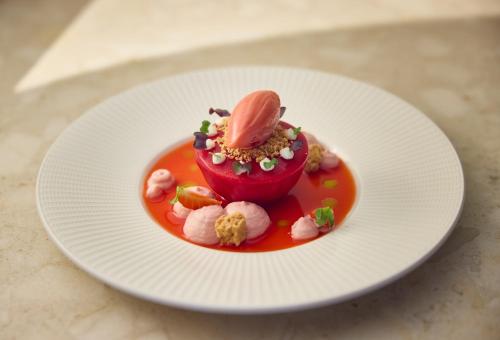 a dessert on a white plate on a table at DoubleTree by Hilton Hannover Schweizerhof in Hannover