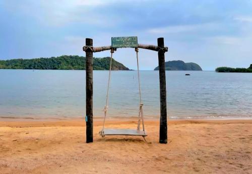 a swing on the beach next to the water at Laem Tukkata beach Koh Mak in Ko Mak